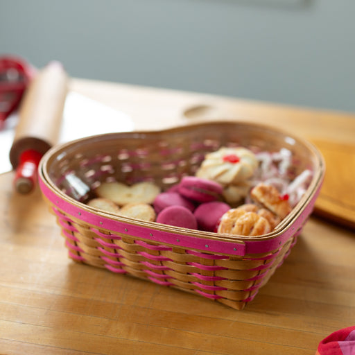 Basket of cookies on a wooden table with a rolling pin in the background