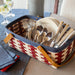 Americana Large Handled Rectangle Organizing Basket Set with Protector holding flatware and plates.