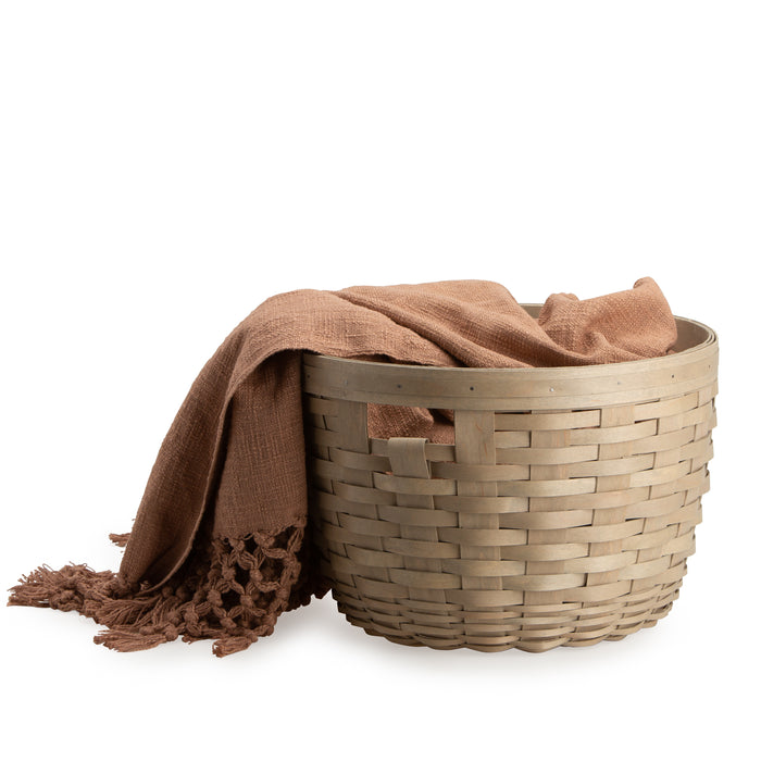Light Brown Corn Basket shown holding blanket.