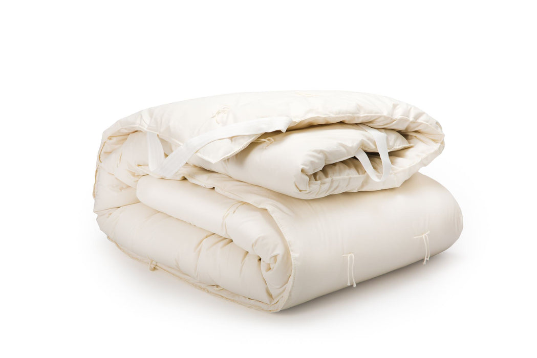 Wool mattress topper or mattress pad folded on white background
